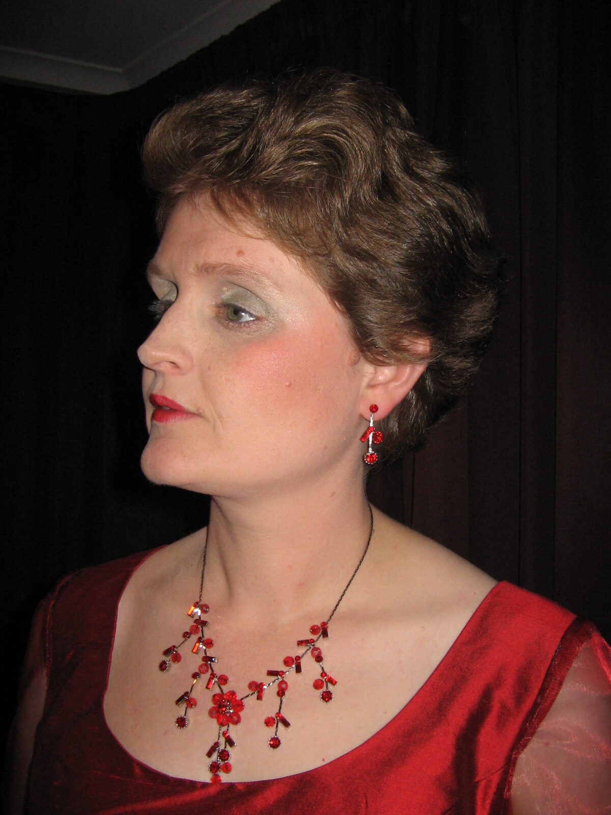 Lisette in a red dress and red necklace.